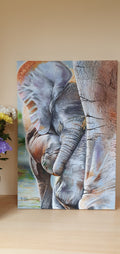 Original oil painting of a baby elephant standing close to its mother's leg, warm and tender wildlife art by Alina Laura Anton