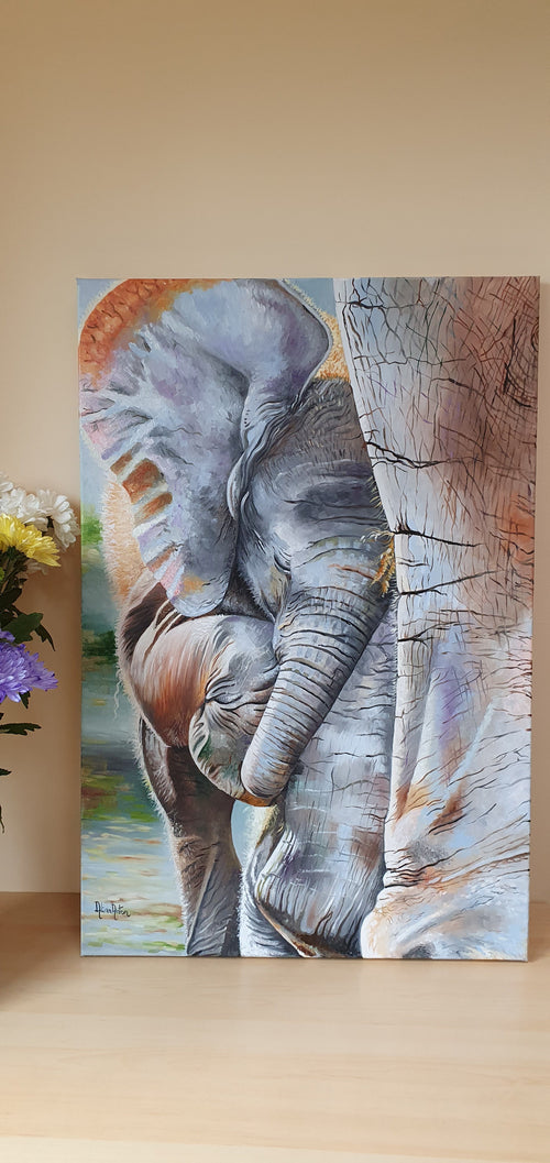 Original oil painting of a baby elephant standing close to its mother's leg, warm and tender wildlife art by Alina Laura Anton