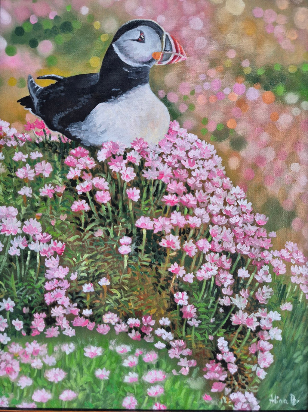 Original oil painting of a puffin sitting amongst sea pink flowers on the Irish coast